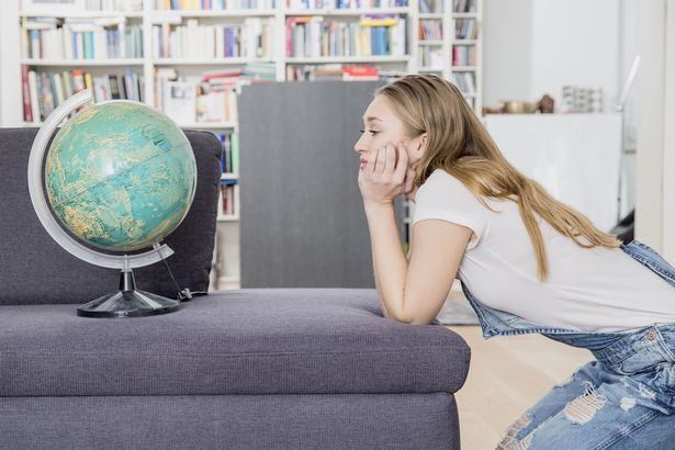 Woman-daydreaming-with-globe
