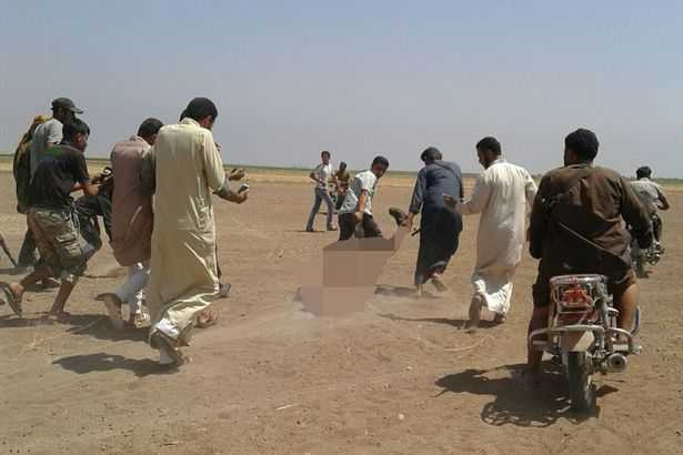 Civilians-appear-to-be-dragging-the-body-of-a-Russian-pilot-dragged-from-the-wreckage-of-a-Russian-helicopter-that-had