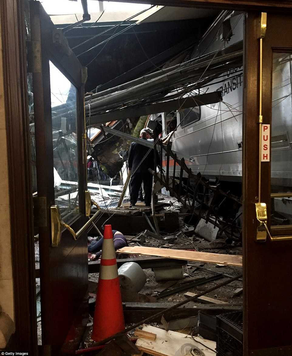 38EBBB9400000578-3813781-A_woman_is_seen_lying_on_the_ground_next_to_the_crashed_train_as-a-64_1475159193776