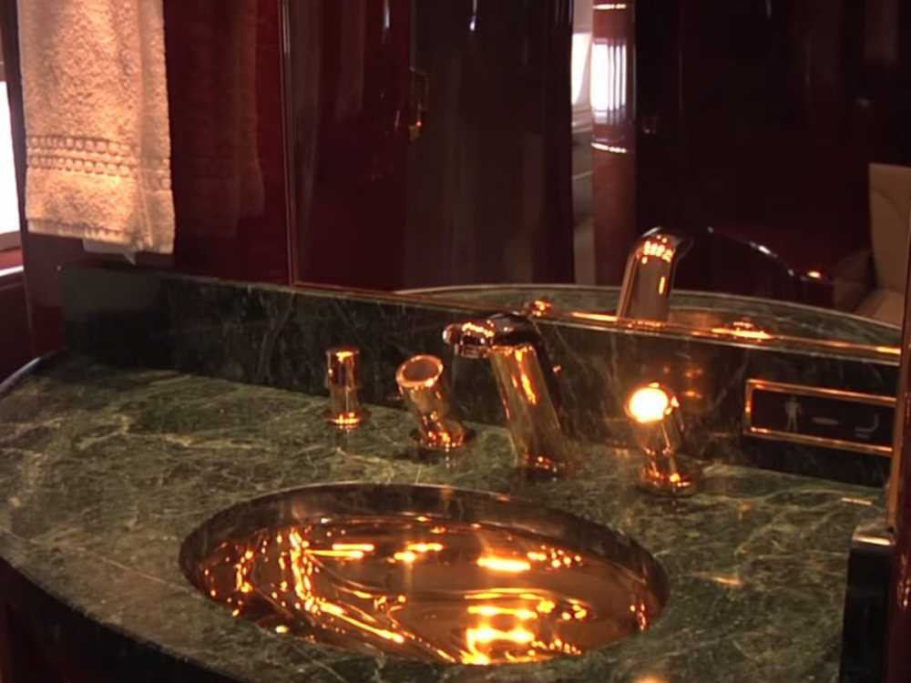 -a-master-bath-with-24-karat-gold-fixtures-and-