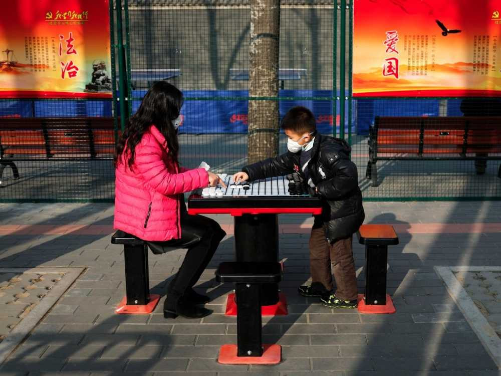 but-life-must-go-on-here-a-mother-and-son-bond-outdoors-despite-a-heavily-polluted-day-in-beijing