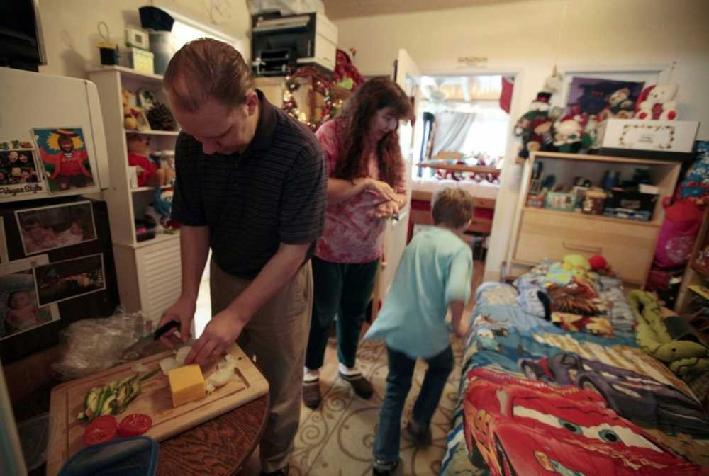 the-burger-family-from-los-angeles-gets-ready-in-a-converted-garage-in-wife-elizabeth-burgers-mothers-home-the-family-lost-their-home-in-2009-and-was-forced-to-sell-their-possessions