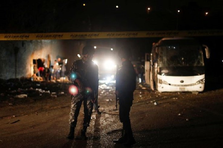 0_Police-officers-inspect-a-scene-of-a-bus-blast-in-Giza 7