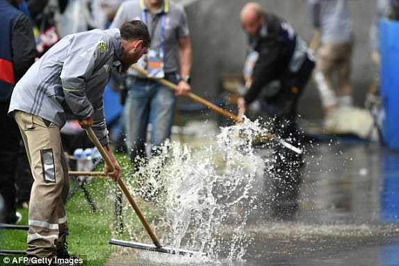 1465843856899_lc_galleryImage_Workers_clear_water_from_