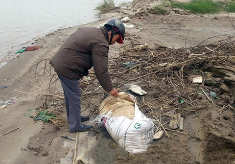  Kiểm tra từng bao tải, túi nilon ven bờ (Ảnh do gia đình cung cấp)