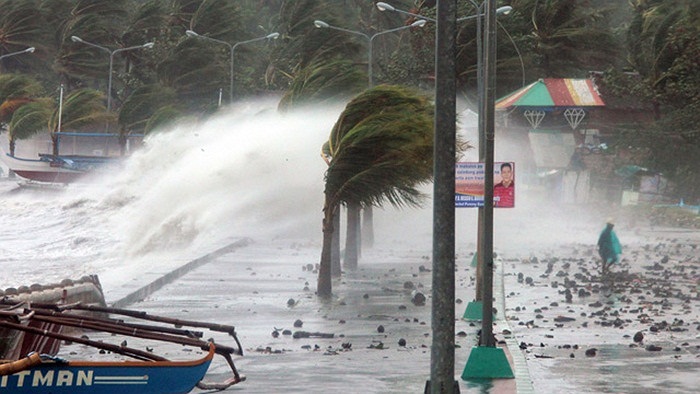 Người dân đi bộ bên bờ biển khi sóng do siêu bão Haiyan đập vào tại thành phố Legaspi, tỉnh Albay, phía nam Manila