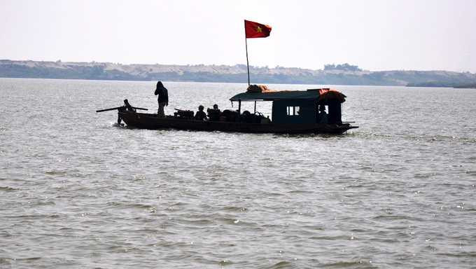 Người nhà chị Lê Thị Thanh Huyền tìm kiếm nạn nhân ở khu vực bến đò và dọc bờ sông Hồng - Ảnh: Quang Thế