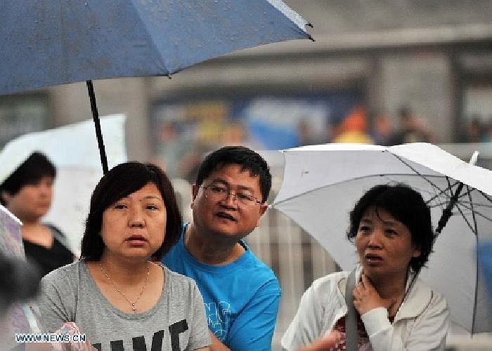 Phụ huynh nhìn con em họ bước vào trường thi.