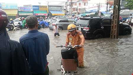 CSGT giúp đẩy chiếc xe đạp của một em học sinh. (Nguồn ảnh : Fanpage Tôi Yêu Đồng Nai)