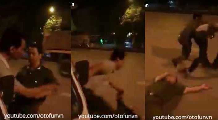 Khi người đàn ông áo trắng vừa đưa tay chạm vào viên công an thì anh này ngã xuống. Ảnh cắt từ clip