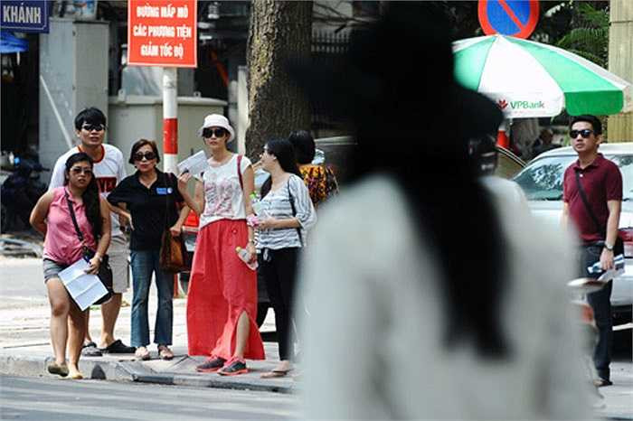 Những vị khách du lịch không hiểu điều gì đang xảy ra ở bên kia đường.