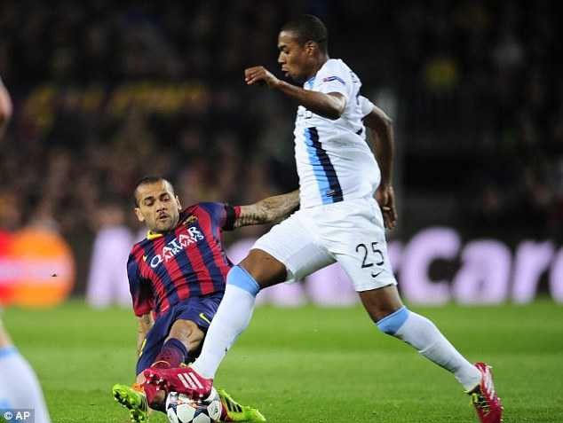 Sliding in: Barcelona's Daniel Alves fights for the ball with Fernandinho