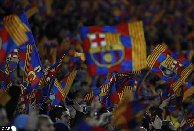 Display: Barcelona fans wave flags before the start of the second leg at the Nou Camp