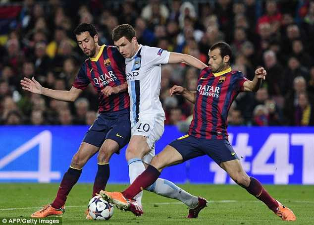 Surrounded: Substitute Edin Dzeko is closed down by Sergio Busquets (left) and Javier Mascherano (right