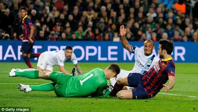 Desperate: Cesc Fabregas slides in on goalkeeper Joe Hart in the six yard box