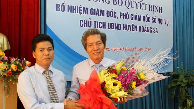 Ông Võ Công Chánh (trái) chủ tịch UBND huyện Hoàng Sa tặng hoa chia tay ông Đặng Công Ngữ - Ảnh: Hữu Khá 