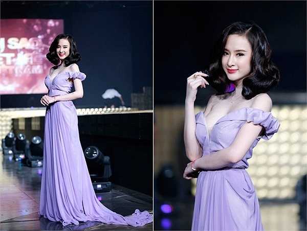 Mẫu đầm dạ hội được thiết kế trên chất liệu vải lụa tím với chi tiết trễ vai gợi cảm đã giúp cô níu kéo ánh mắt người nhìn. 