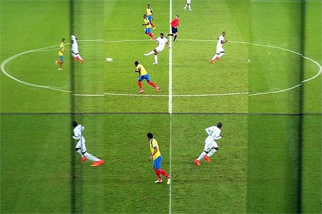 Lỗi hình ảnh? Không hề. Ở đây tác giả đã cố tình sử dụng màn hình thủy tinh bên trong sân vận động để tạo ra một hiệu ứng lạ mắt.