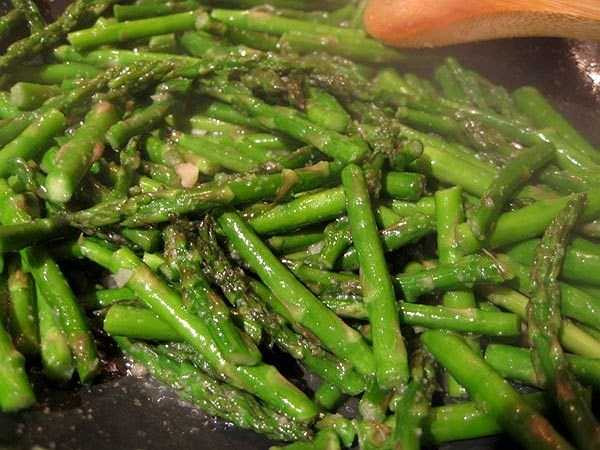 Măng tây xào tỏi. Măng tây rửa sạch, bỏ phần gốc già. Cắt làm đôi. Đun nước sôi, cho ít muối vào, thả măng tây vào luộc khoảng 1 phút rưỡi đến 2 phút, chắt bỏ nước. Cho tiếp vào nồi nước luộc gà, xì dầu, đường, muối, trộn đều và đun sôi trở lại. Cho dầu mè vào chảo, cho tiếp dầu salad , gừng và tỏi, xào thơm. Đổ măng tây vào, xào tiếp, măng chín, bầy ra đĩa, rắc tỏi và gừng lên trên.