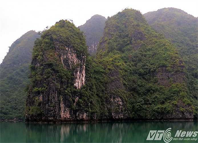 Đảo đá vôi tuyệt đẹp in hình trên mặt biển trong xanh, phẳng lặng, phảng phất sương sớm