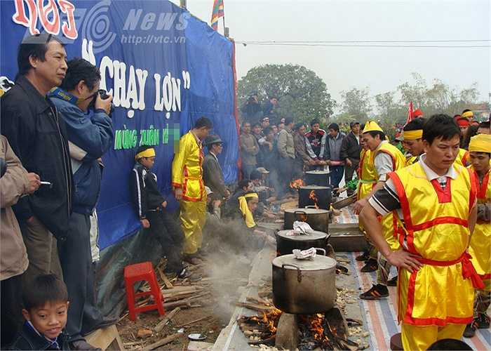 Trên sân khấu giữa ao đình, những nổi nước lớn đã được nổi lửa, sôi ùng ục, khói bay mù mịt.
