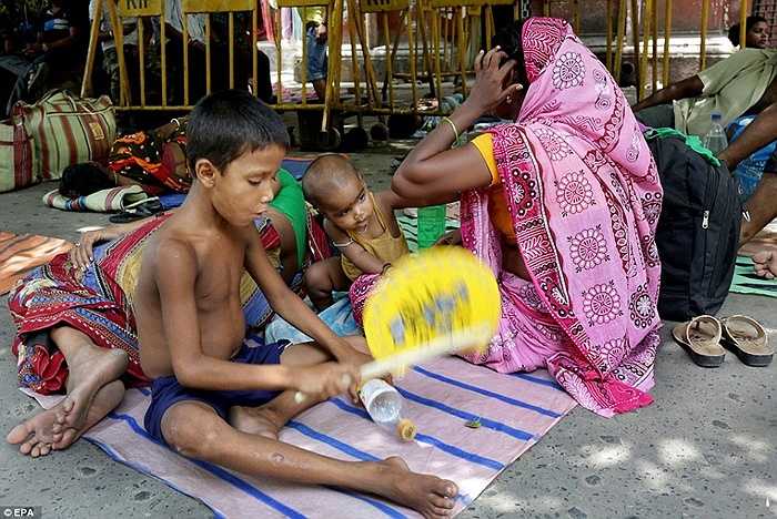 Một gia đình ở Calcutta, Ấn Độ chờ đợi để được điều trị y tế