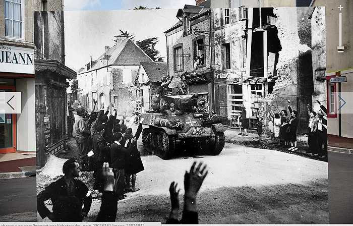 Xe bọc thép chở binh lính đi qua một con đường ở thị trấn Sainte Mere Eglise của Pháp ngày đổ bộ