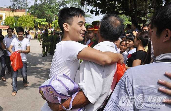 Trong ảnh, người bố tay ôm túi đồ, ôm chầm lấy con trai trong ngày con được đặc xá, trở về với gia đình sau những tháng ngày chấp hành án phạt trong trại giam.