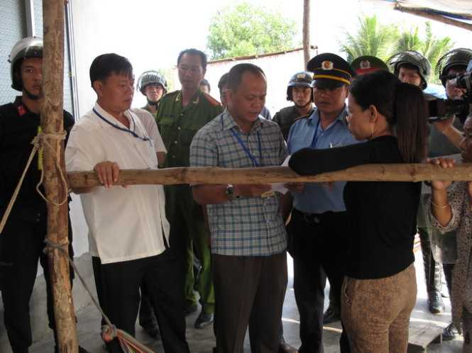 Lãnh đạo huyện Phú Quốc tiếp cận và thuyết phục cha bà Hồng khuyên con gái chấp hành quyết định cưỡng chế - Ảnh: Duy Khánh