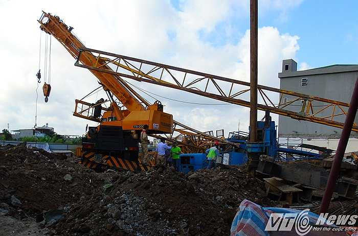 Bên trong công trường, các phương tiện máy cẩu, máy đóng cọc bị hư hỏng nặng.