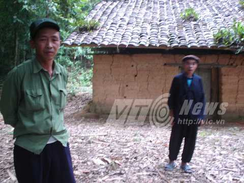 Xã đội trưởng Vàng Sải Phin phải và thầy cúng Lù Vần Xẻng trước ngôi đền trong rừng cấm của người Nùng