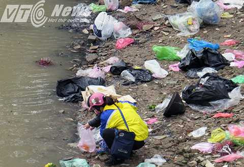 Khu vực chân cầu Xi Măng (quận Hồng Bàng), hai bên bờ sông vúi nilon đựng cá, đồ thờ cúng vứt la liệt, trôi lềnh bềnh trên mặt sông