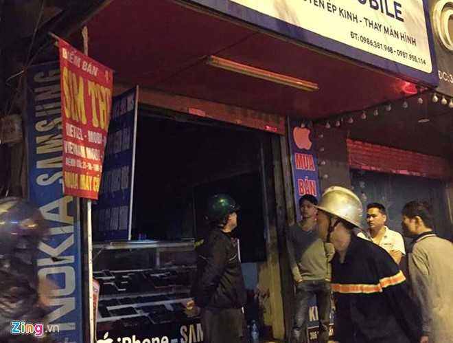 Lực lượng chức năng phong tỏa hiện trường vụ cháy cửa hàng điện thoại di động sau khi dập tắt ngọn lửa. Ảnh: Hoàn Nguyễn
