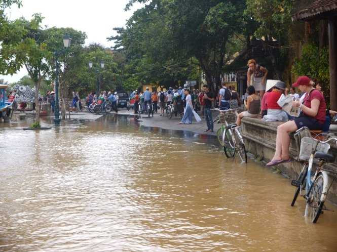 Người dân và du khách theo dõi lũ trên sông Hoài - Ảnh: THANH BA