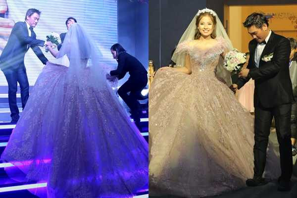 Diễn viên Khánh Hiền diện váy cưới dáng xòe rộng cổ điển trong tiệc cưới ở TP HCM tối 6/11. Chiếc váy phồng to, dài quét đất khiến cô khó di chuyển. Thậm chí, khi tiến vào sân khấu, chú rể James Ngô đã sơ ý giẫm cả vào váy của cô dâu. Khi lên sân khấu, ông xã và một nhân viên nhà hàng tiệc cưới phải đỡ Khánh Hiền vì sợ cô vấp ngã. >> Xem thêm Khánh Hiền đẹp lộng lẫy khi làm cô dâu