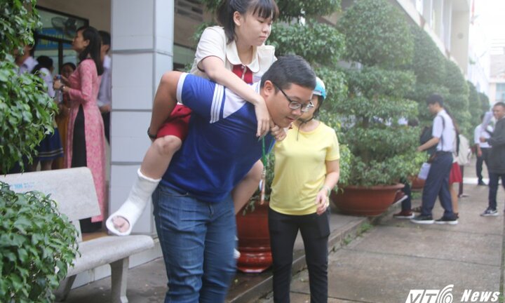 Xúc động hình ảnh thí sinh gãy chân được tình nguyện viên cõng lên tận phòng thi