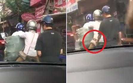Người đi đường dửng dưng nhìn gã đàn ông móc ví phụ nữ giữa phố Hà Nội