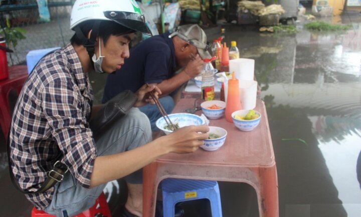 Mưa lớn hơn 2 tiếng, dân Sài Gòn ăn trưa giữa biển nước
