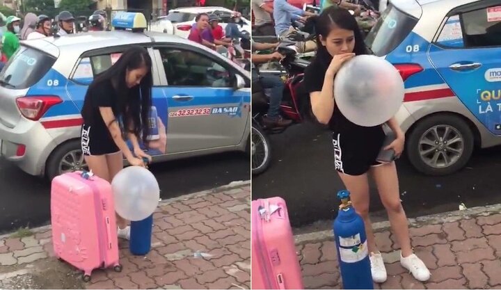 Xôn xao clip thiếu nữ xinh đẹp vác theo bình khí, hít bóng cười giữa phố Hà Nội