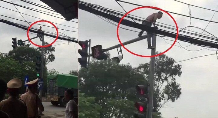 Clip: Bị CSGT thu xe, nam thanh niên leo lên cột đèn giao thông ăn vạ