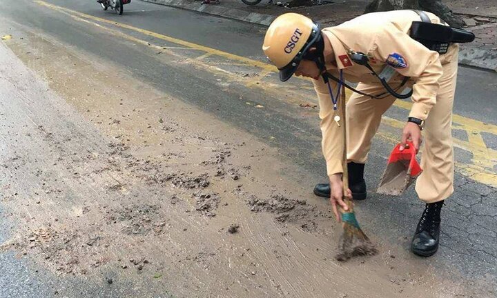 CSGT Hà Nội xúc bùn giữa đường, giúp dân tránh tai nạn giao thông