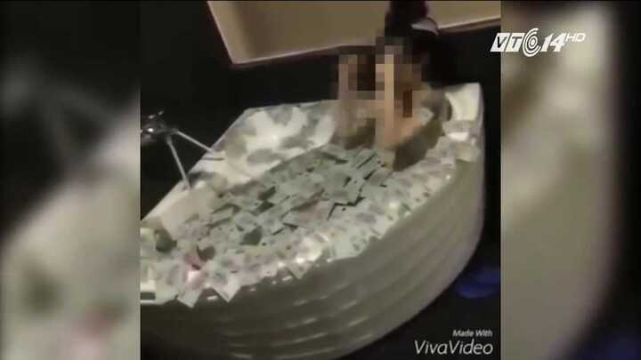 Clip cô gái tắm bằng tiền gây tranh cãi trên mạng xã hội