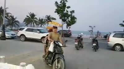 Video: 2 cha con đội khay bánh đi xe máy như diễn xiếc ở Đà Nẵng