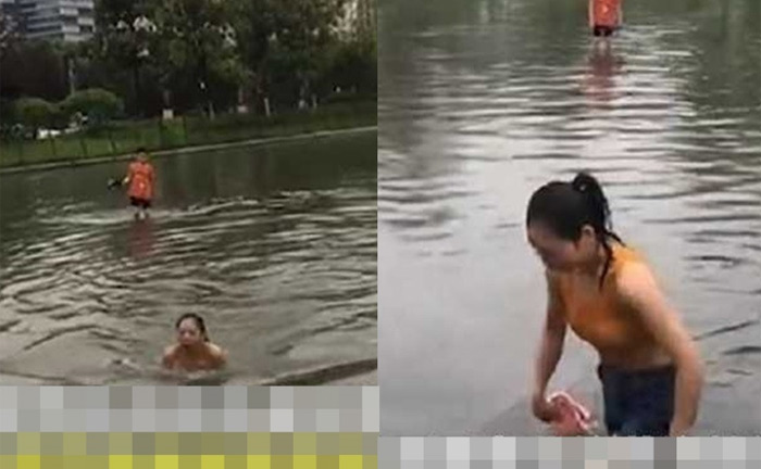 Mưa ngập, cô gái bơi giữa phố để tới chỗ làm khiến dân mạng tranh cãi