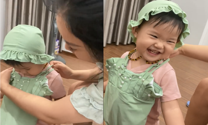 Được khen xinh, bé gái cười tít mắt