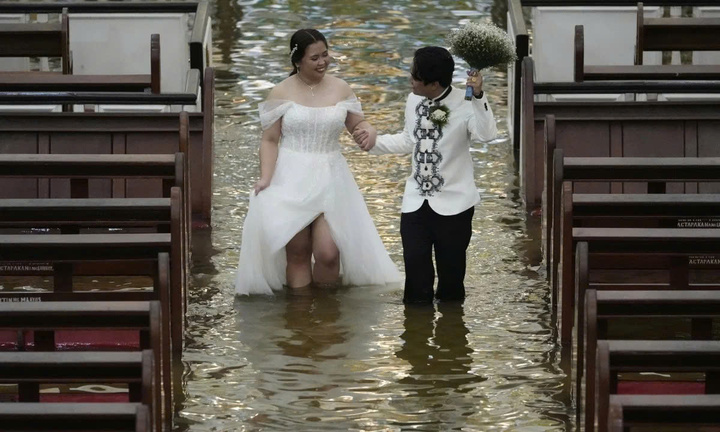 Cặp đôi Philippines làm lễ cưới giữa dòng nước ngập sau bão Wipha