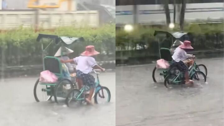 Xúc động em nhỏ còng lưng đạp xe, đẩy xe người khuyết tật khi mưa to, đường ngập