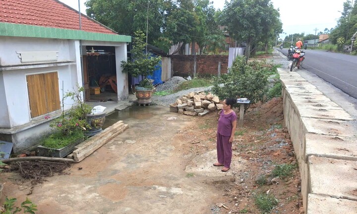Upgrading National Highway 14E has caused hardship for residents as their houses are now "hidden" in the road.
