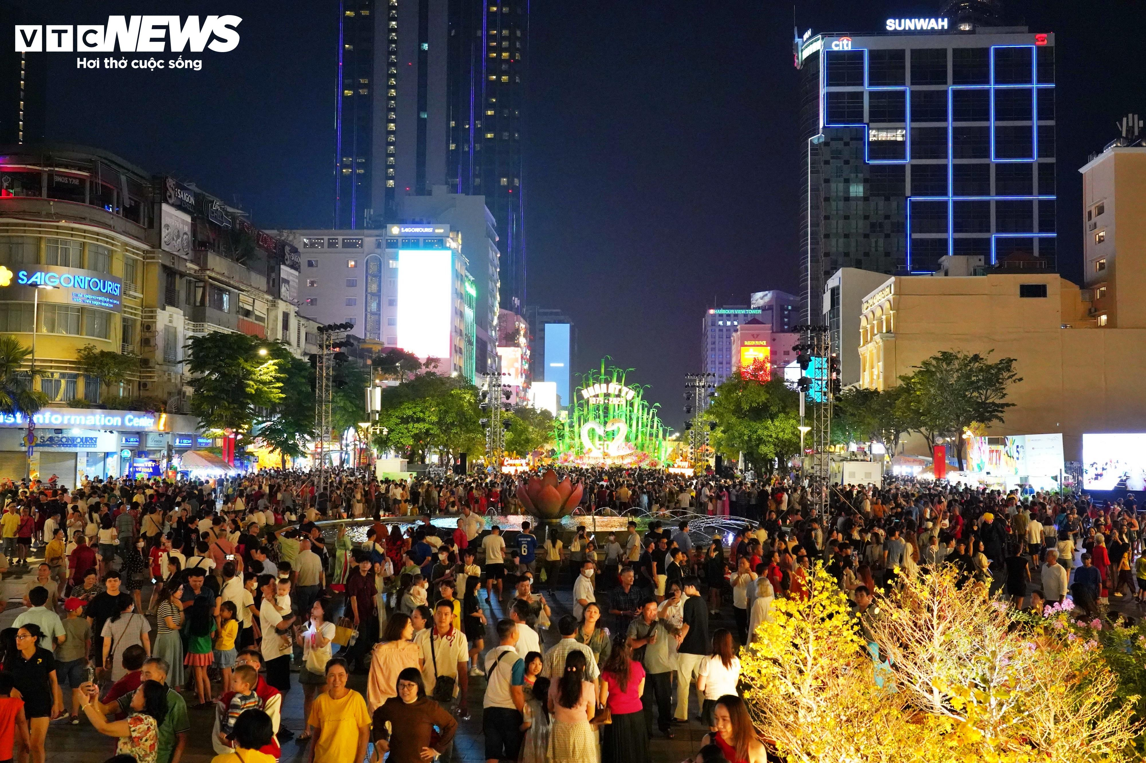 Du khách đứng chật kín xem khai mạc đường hoa Nguyễn Huệ - 14