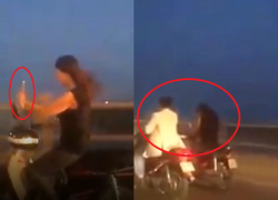 Thiếu nữ vừa lái xe máy vừa chụp ảnh 'tự sướng' trên cầu Vĩnh Tuy